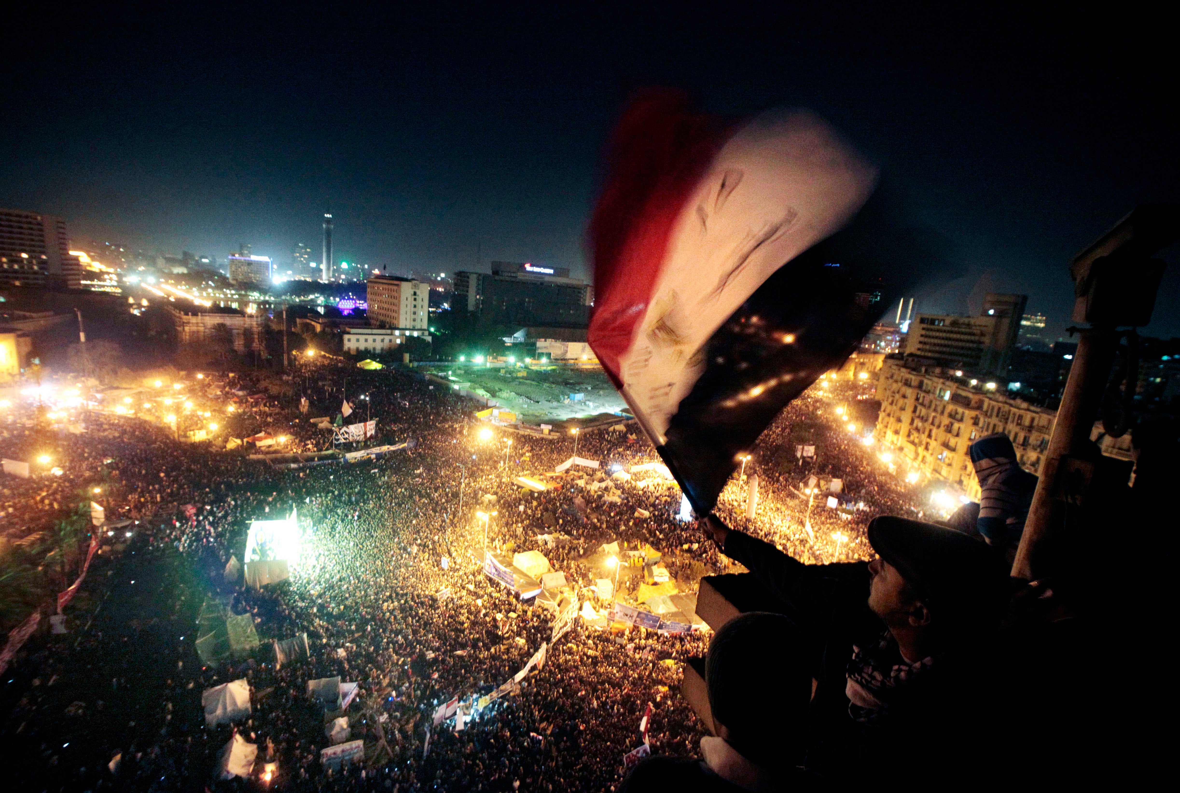 People mark the first anniversary of the popular uprising in Tahrir Square, Cairo