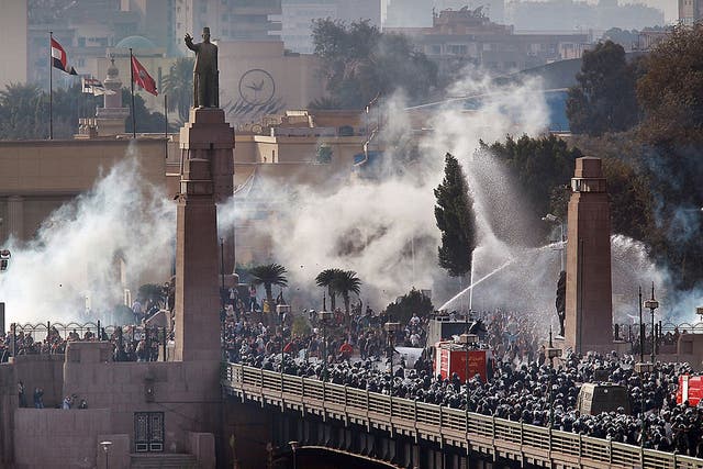 <p>Riot police force protestors back across the Qasr El Nil bridge as they attempt to get into Tahrir Square on 28 January 2011 in downtown Cairo</p>