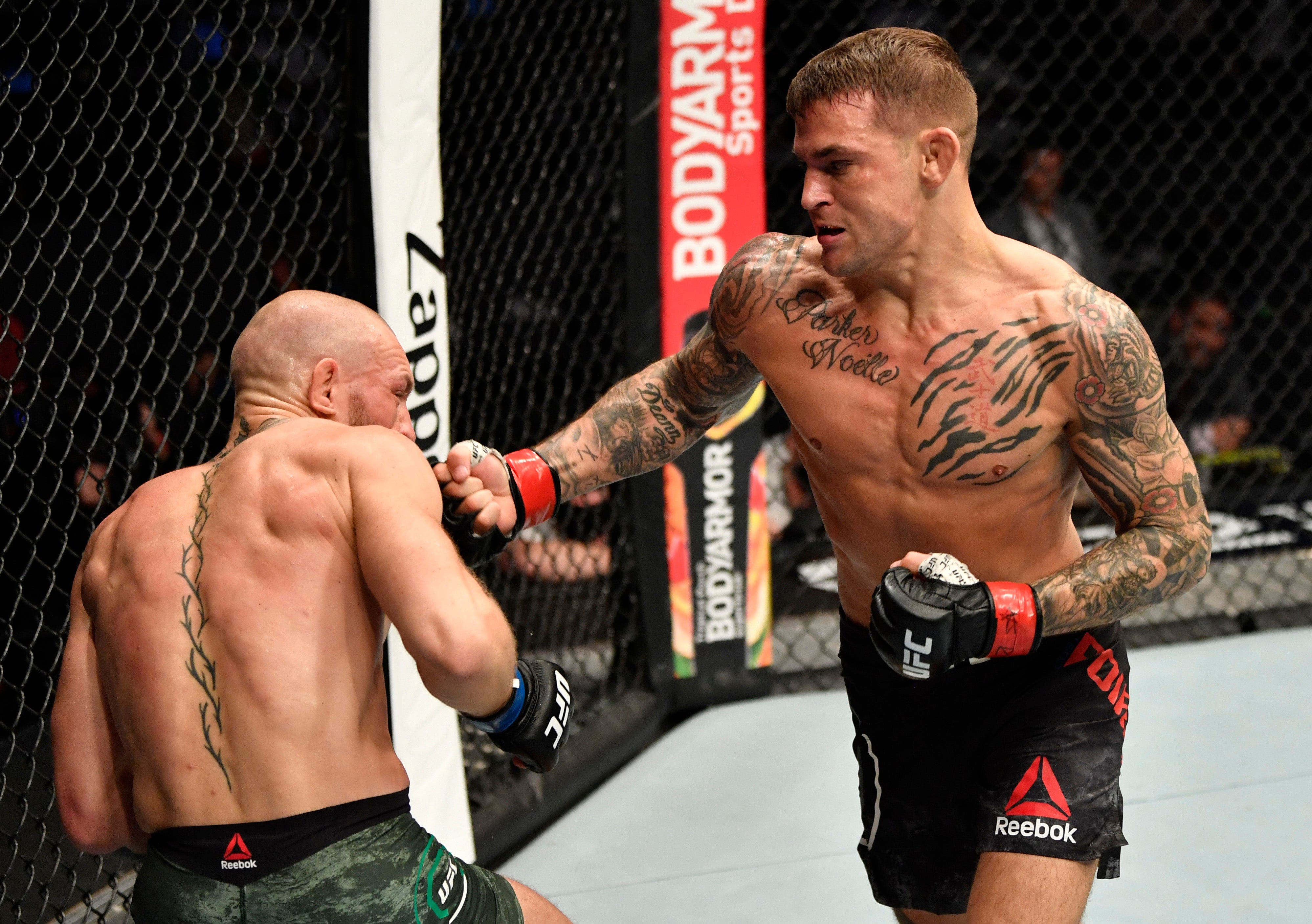 Conor McGregor, left, moments before losing to Dustin Poirier