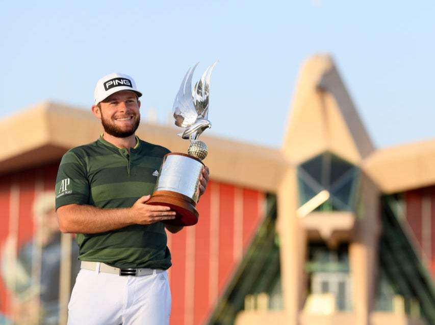Tyrrell Hatton celebrates with the trophy