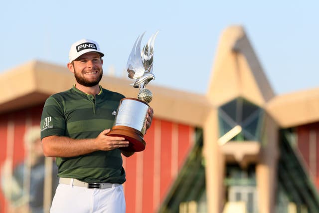 <p>Tyrrell Hatton celebrates with the trophy</p>
