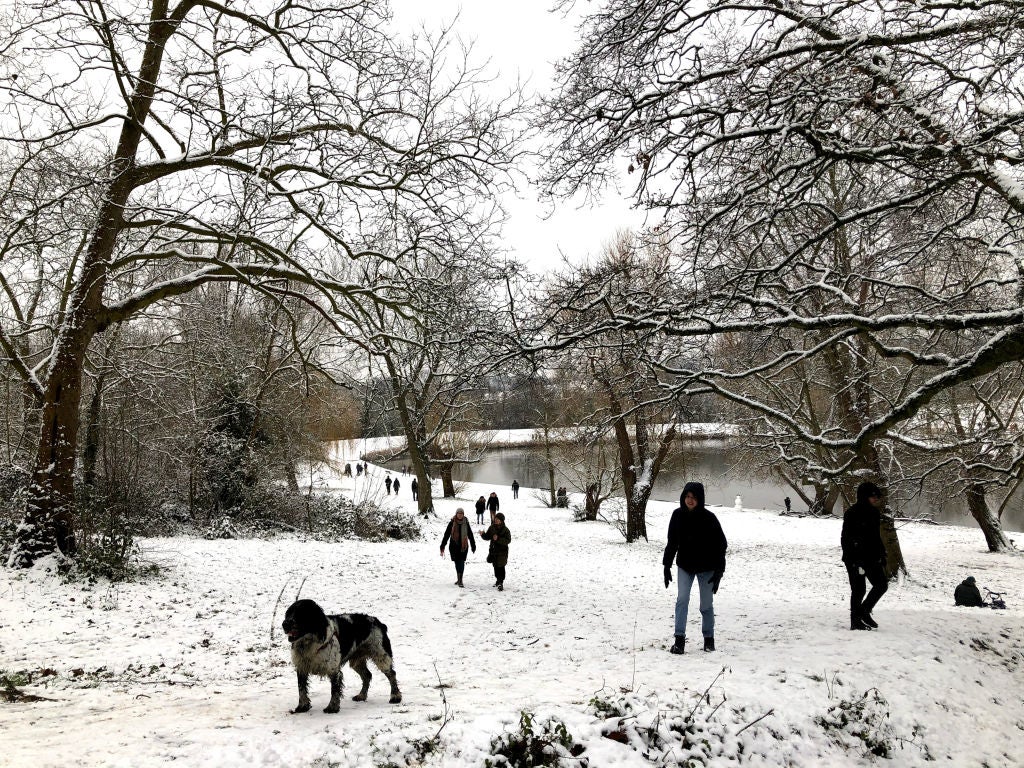 Londoners walk in snow on Hampstead Heath on Sunday