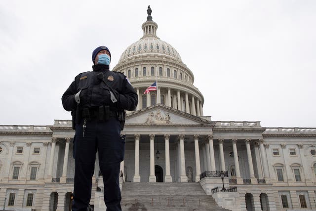 <p>A Capitol Police officer stands at the East Front of the US Capitol</p>