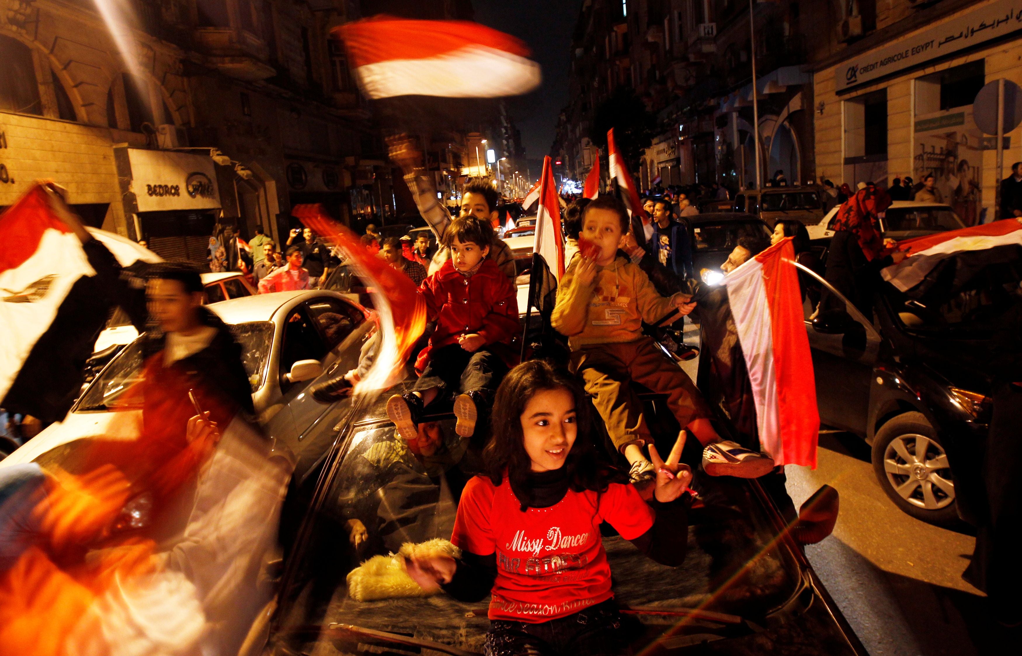Egyptians celebrate after the announcement of President Hosni Mubarak’s resignation in February 2011
