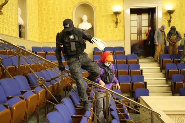 <p>Protesters enter the Senate Chamber on 6 January 2021 in Washington, DC</p>