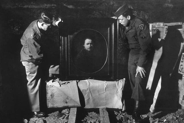 <p>A US soldier inspects priceless art taken from Jews by the Nazis and stashed in the Heilbronn salt mines in Germany, 3 May 1945. The treasures were uncovered by allied forces after the defeat of Nazi Germany</p>