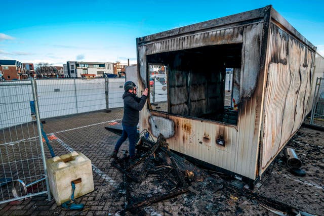 <p>A torched-out coronavirus test centre in the port town of Urk after anti-curfew rioters set it on fire</p>