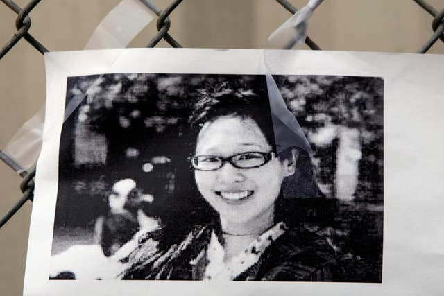 A photocopy showing a photo of Elisa Lam is displayed at a street memorial across the Cecil Hotel in Los Angeles on 21 February 2013