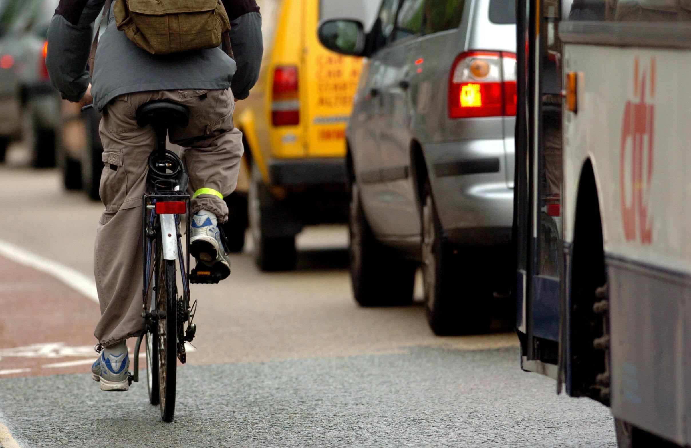 Spain is reportedly forging ahead with measures to keep cyclists safer (file picture of cyclist passing cars in the UK)