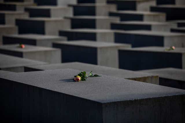 <p>Roses are placed on the Holocaust Memorial on International Holocaust Remembrance Day, 2021, in Berlin, Germany. Today marks the 76th anniversary of the liberation of the Auschwitz</p>