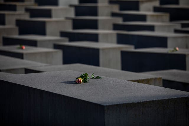 <p>Roses are placed on the Holocaust Memorial on International Holocaust Remembrance Day, 2021, in Berlin, Germany. Today marks the 76th anniversary of the liberation of the Auschwitz</p>