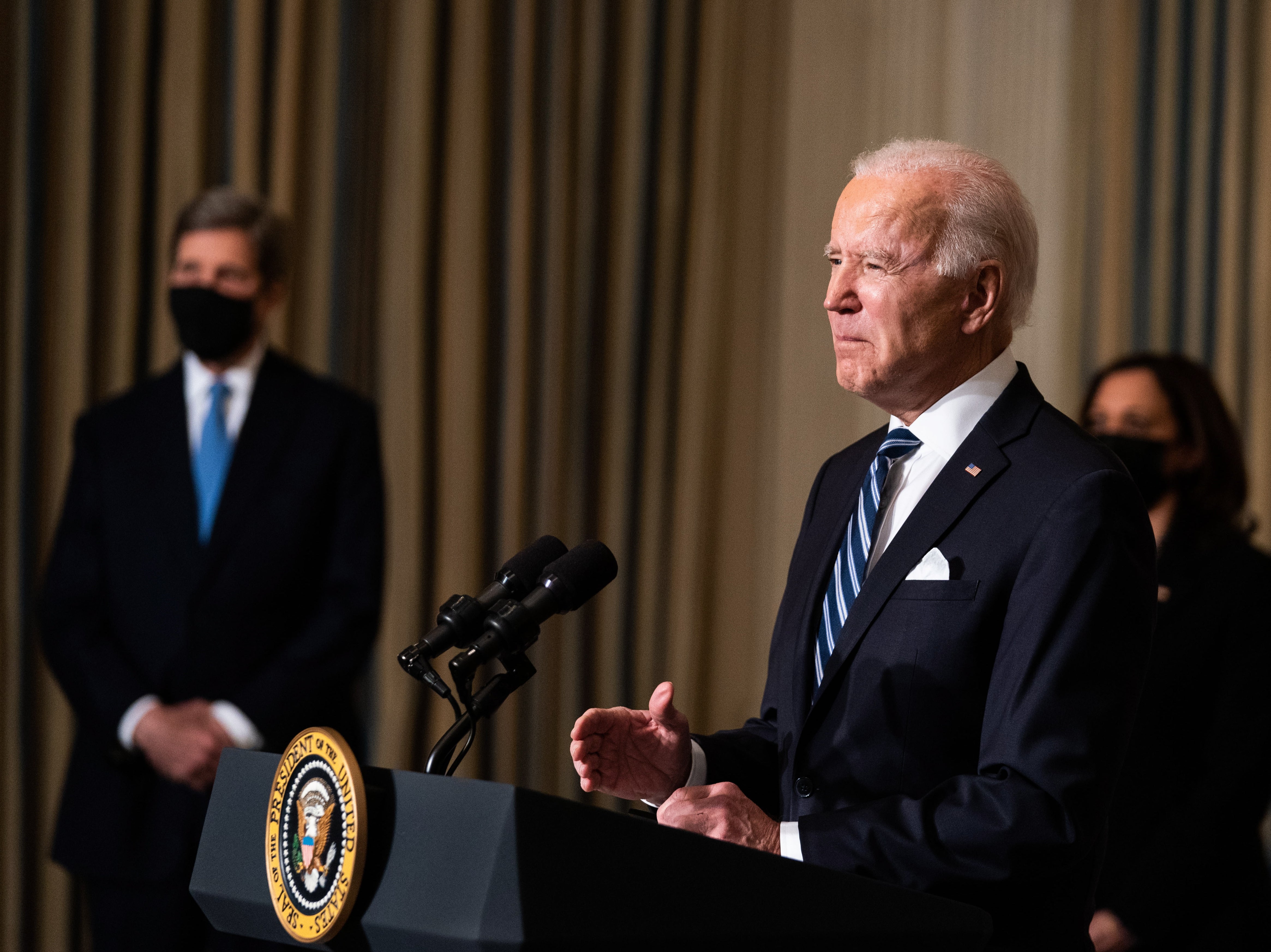  President Joe Biden delivers remarks on his administration’s response to climate change at the White House on 27 January, as VP Kamala Harris and special climate envoy John Kerry look on