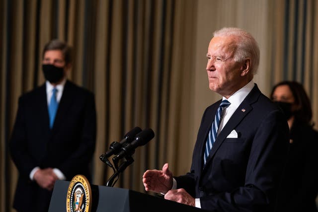  President Joe Biden delivers remarks on his administration’s response to climate change at the White House on 27 January, as VP Kamala Harris and special climate envoy John Kerry look on