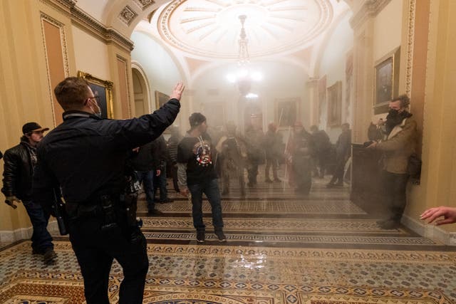 <p>US Capitol Police approach pro-Trump rioters storming the Capitol building on 6 January.</p>