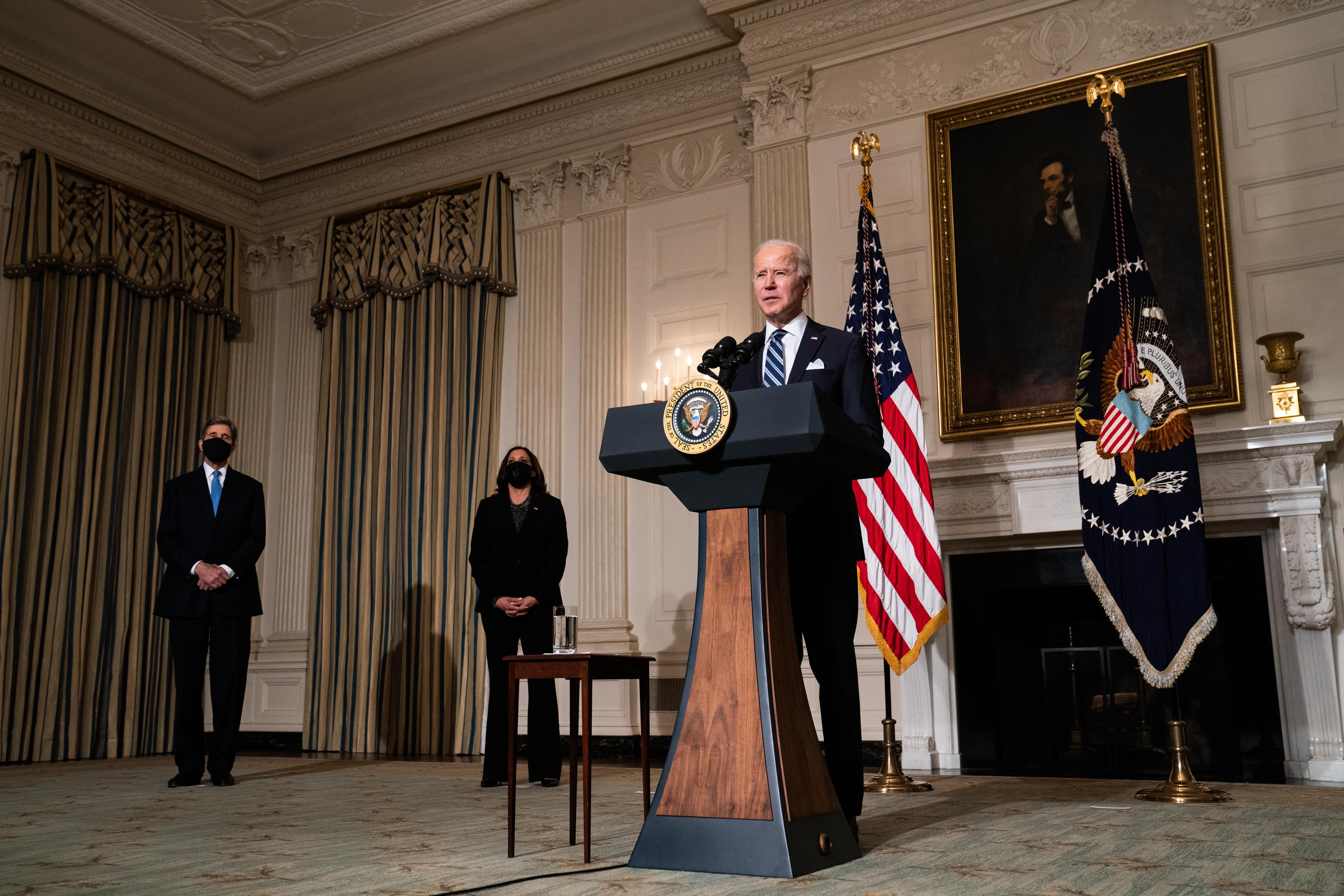 JANUARY 27: US President Joe Biden speaks about climate change issues in the State Dining Room of the White House on January 27, 2021 in Washington, DC. President Biden signed several executive orders related to the climate change crisis on Wednesday, including one directing a pause on new oil and natural gas leases on public lands. Also pictured, left to right, Special Presidential Envoy for Climate John Kerry and US Vice President Kamala Harris.&nbsp;