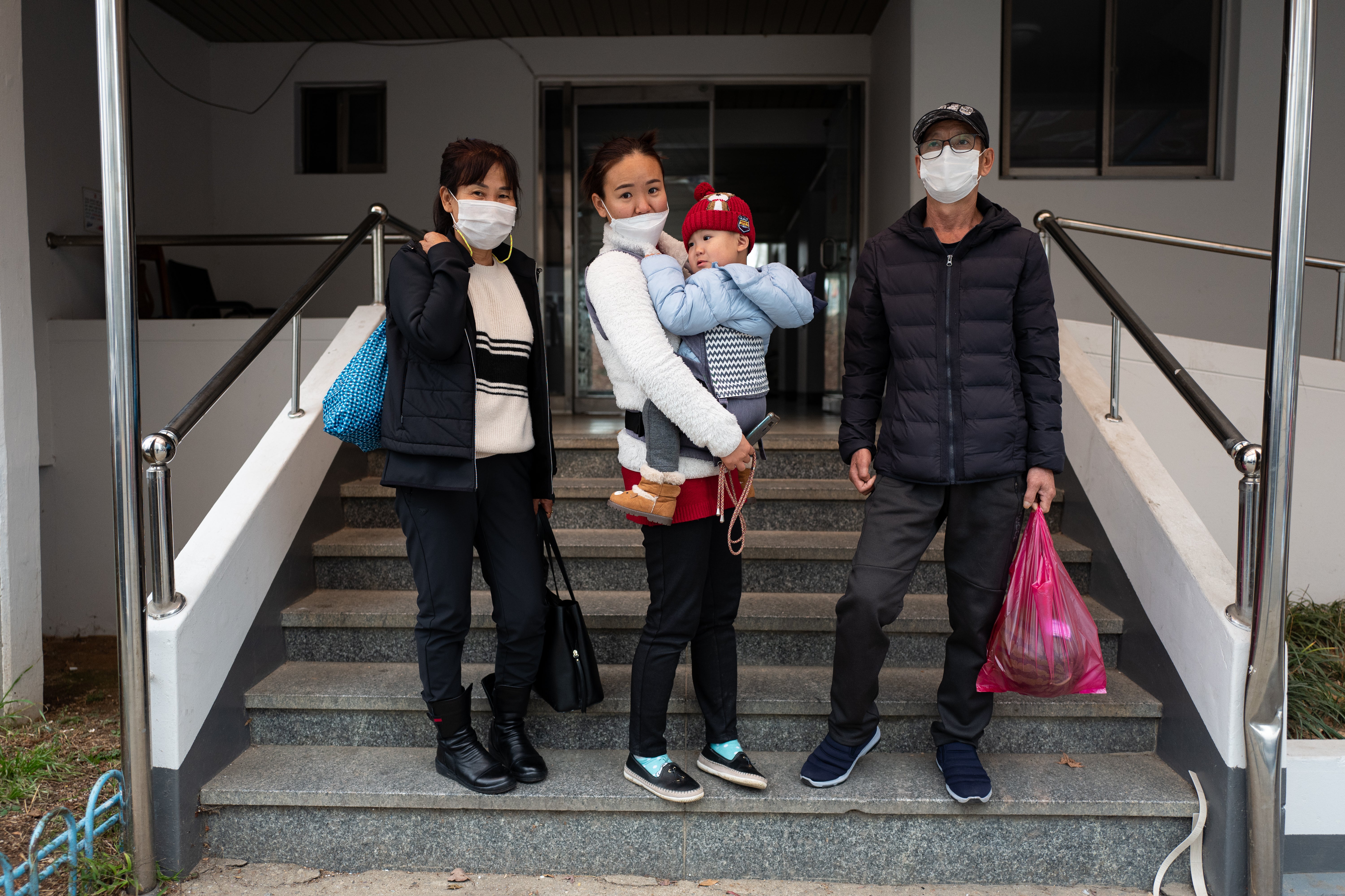 Han Hong-geun with his wife Yeom Bo-bae, their daughter Han Geum-ok and his grandchild pose for photos outside their home in Seosan city