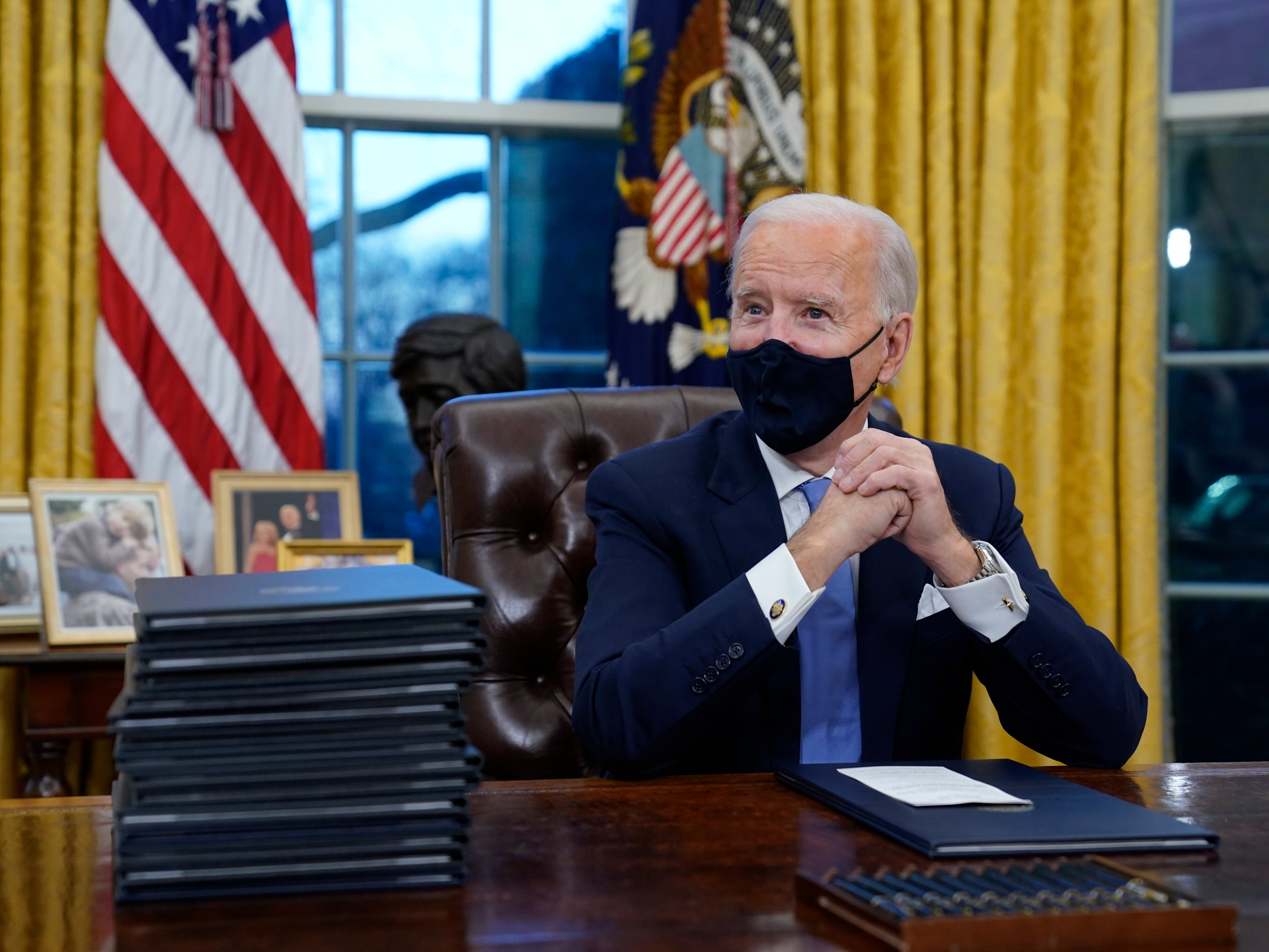 Joe Biden waits to sign his first executive order in the Oval Office of the White House 