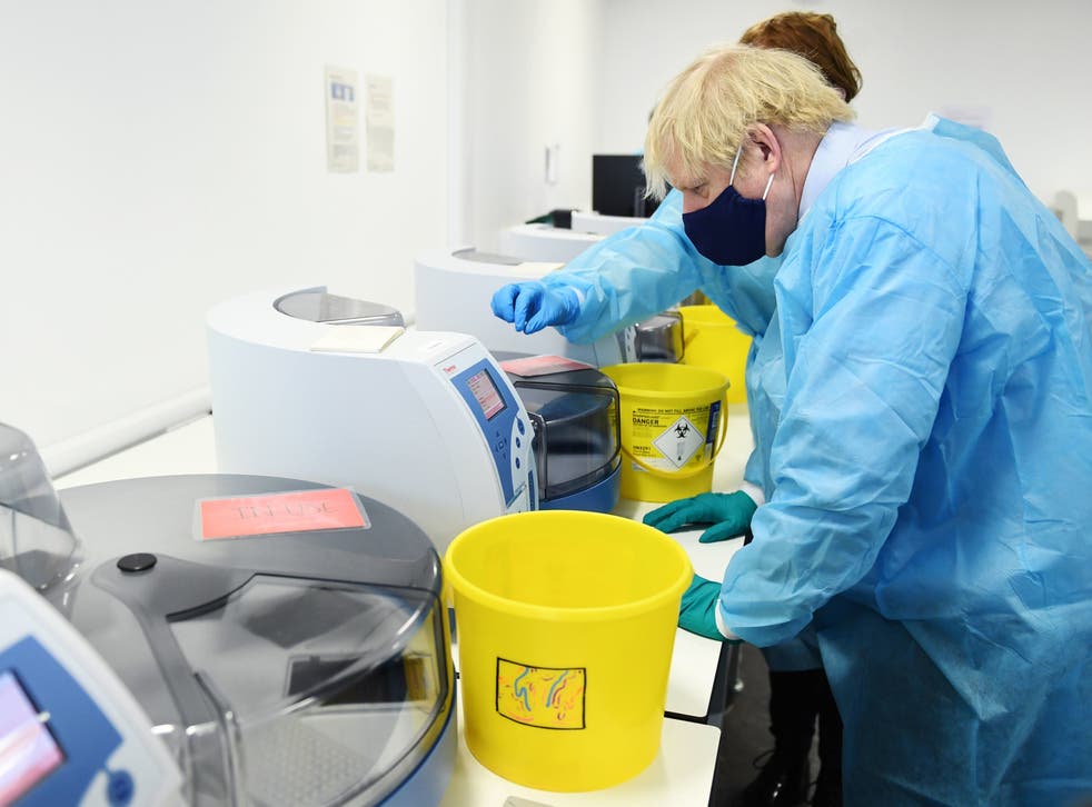 Prime Minister Boris Johnson is shown the Lighthouse Laboratory, used for processing PCR samples for coronavirus, during a visit to the Queen Elizabeth University Hospital campus in Glasgow