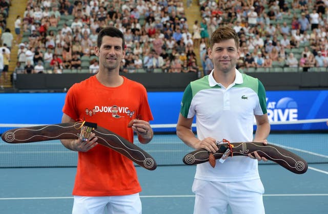 Novak Djokovic and Filip Krajinovic pose for pictures after receiving souvenirs during the ‘A Day at the Drive’ exhibition