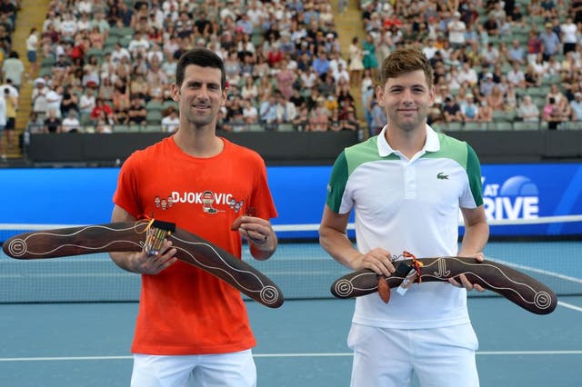 Novak Djokovic and Filip Krajinovic pose for pictures after receiving souvenirs during the ‘A Day at the Drive’ exhibition