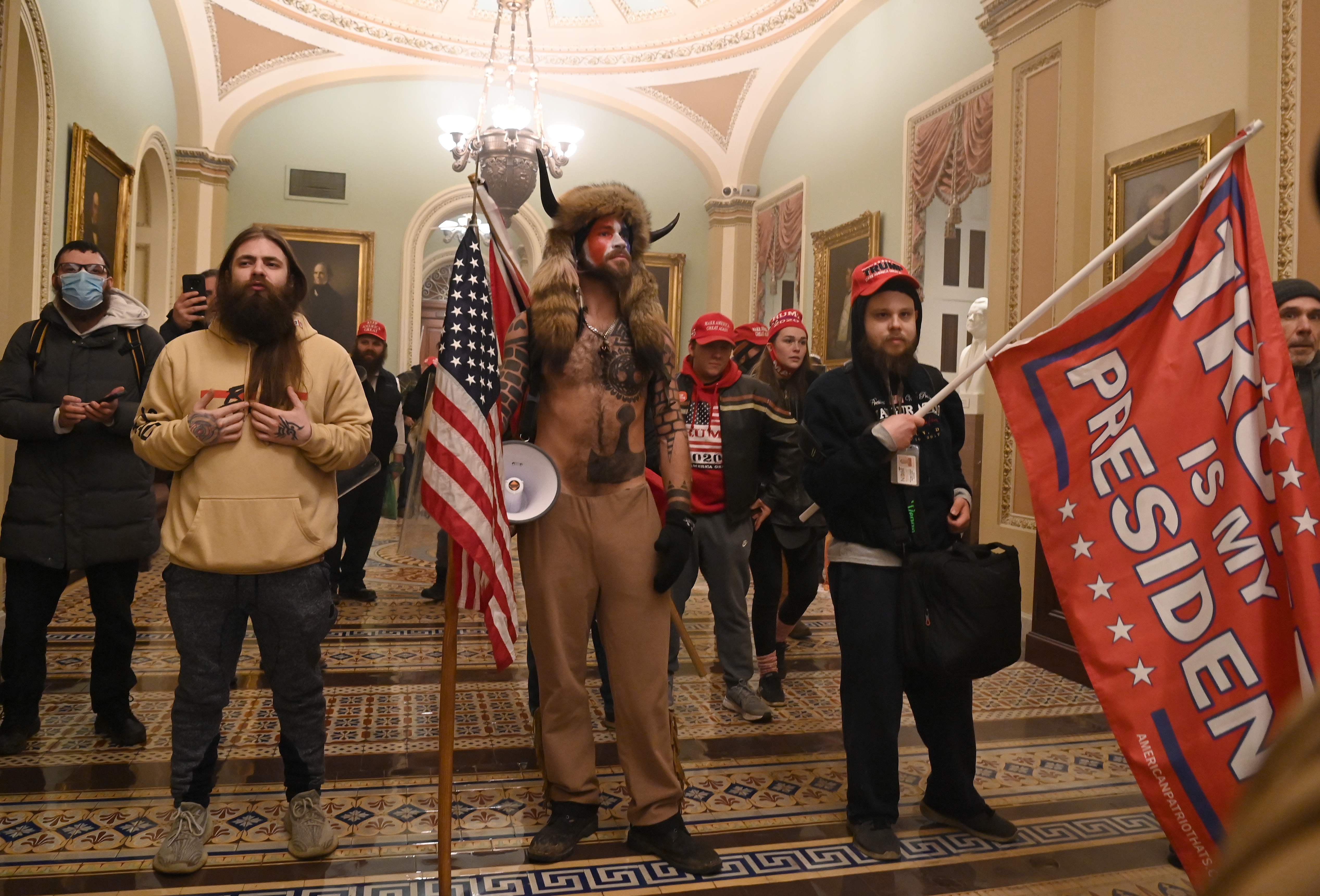 Jake Angeli, aka Yellowstone Wolf, enters the Capitol