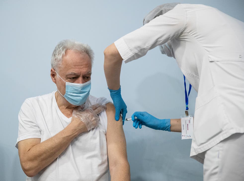 A Russian medical worker administers a shot of the Sputnik V covid vaccine in Moscow