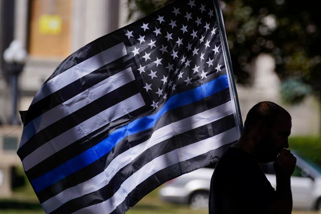 <p>The ‘thin blue line’ flag became a prominent pro-police symbol in 2020 </p>