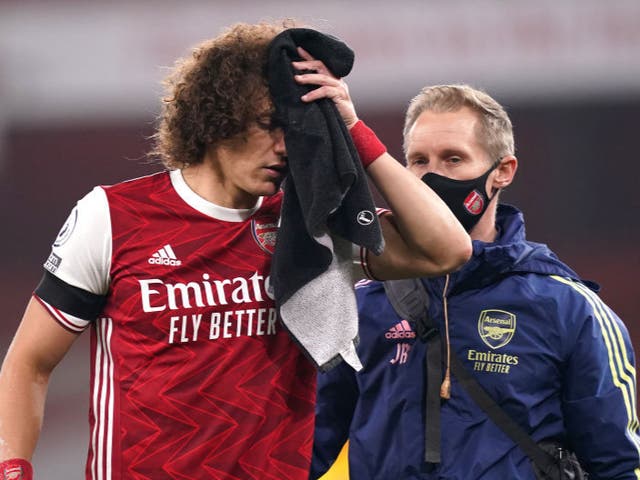 <p>David Luiz of Arsenal receives medical treatment after a collision with Raul Jimenez</p>