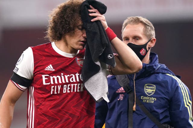 <p>David Luiz of Arsenal receives medical treatment after a collision with Raul Jimenez</p>