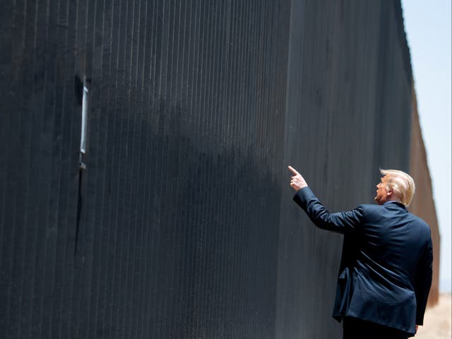 <p>Donald Trump at the border wall with Mexico last year</p>