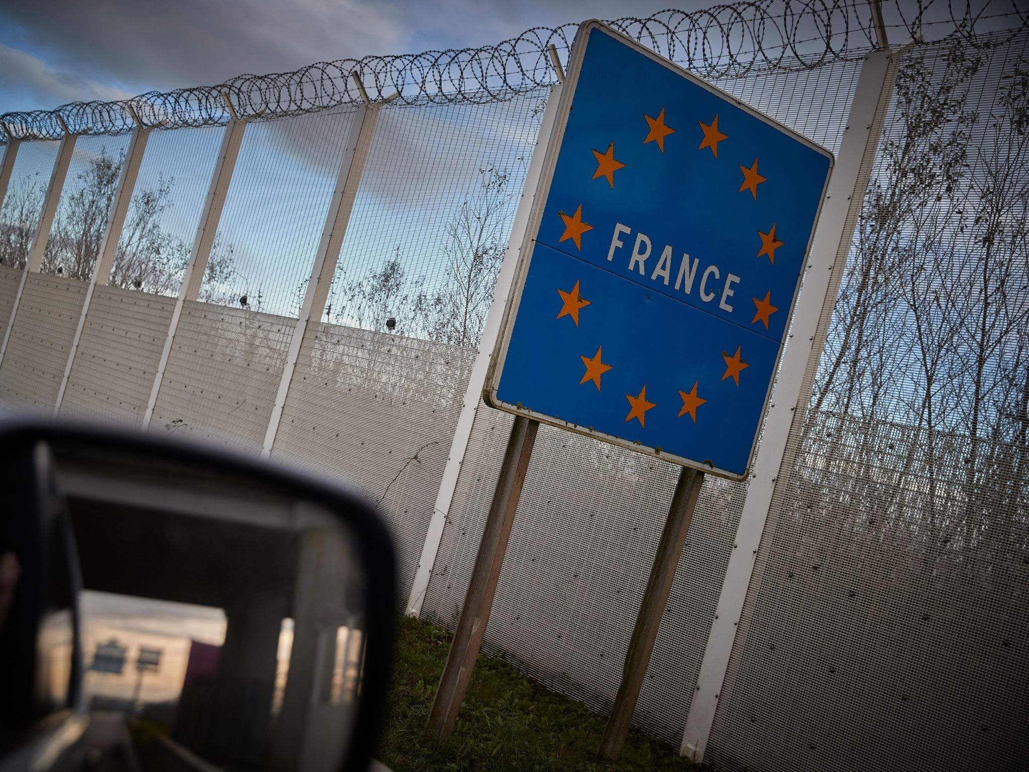 A French border road sign stands at the exit to the Eurotunnel terminal in Calais