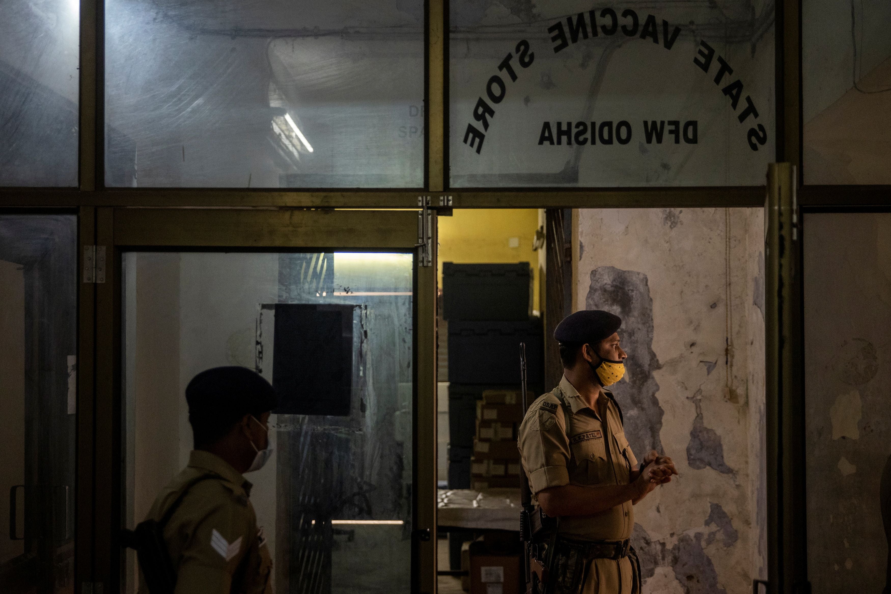 Armed police officers stand guard at the state vaccine storage