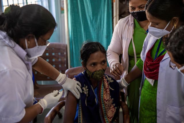 <p>Reena Jani, a health worker, receives a vaccine at a community health centre in India</p>