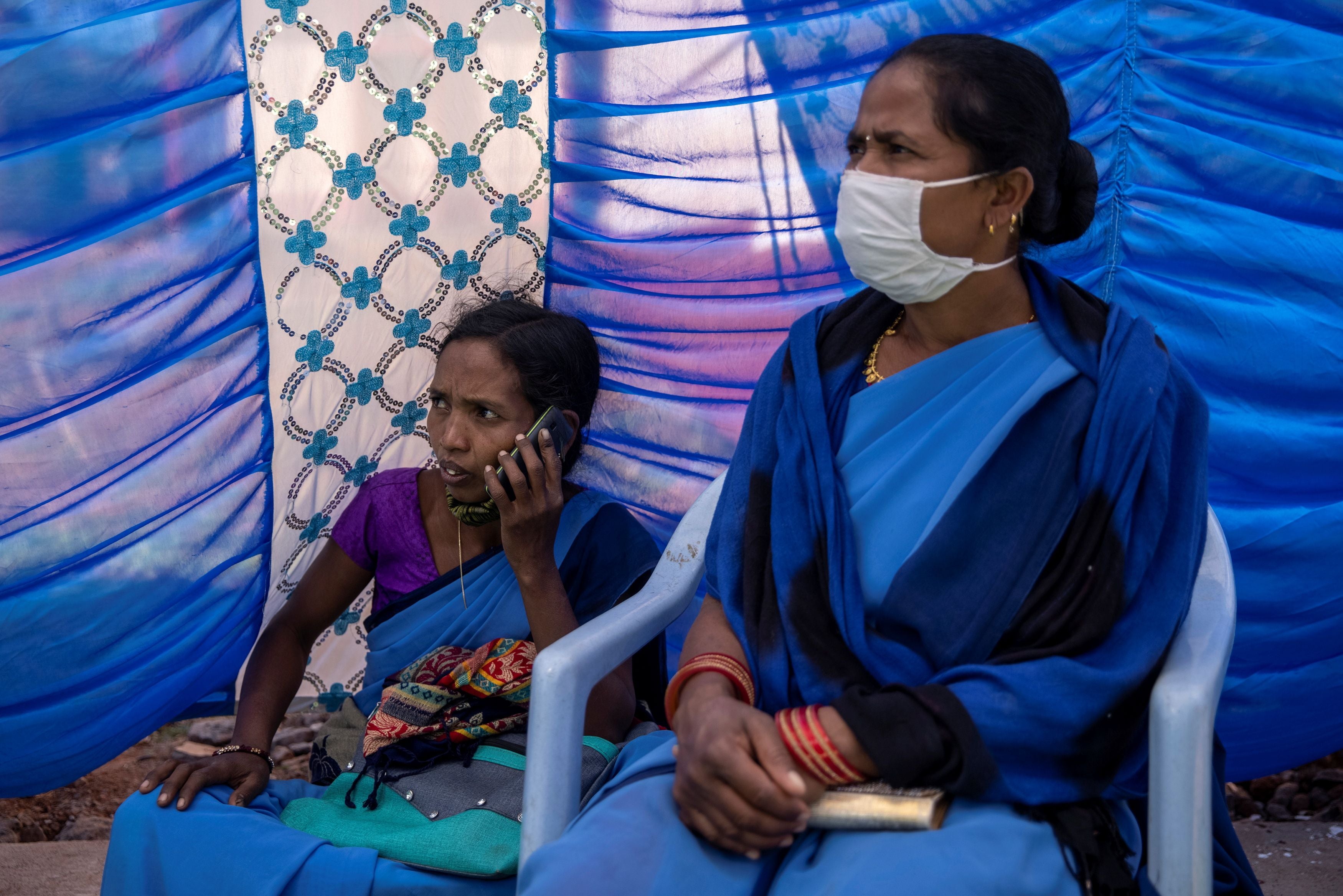 Reena Jani, 34, a health worker, waits to receive the vaccine developed by Oxford-AstraZeneca at Mathalput Community Health Centre, Koraput, India