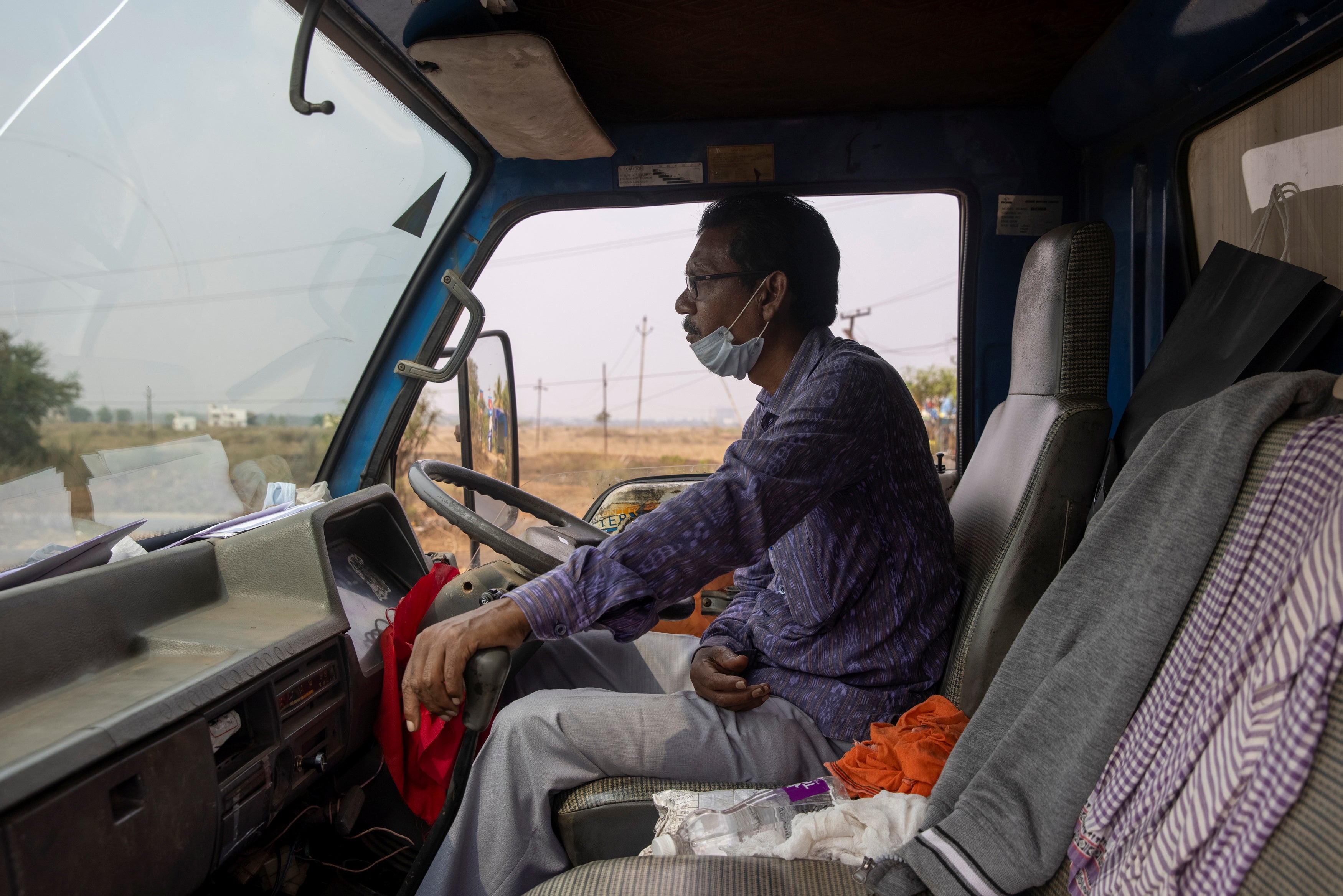 Lalu Porija, a health department driver, transports the vaccine developed by Oxford/AstraZeneca from the state store to a regional one