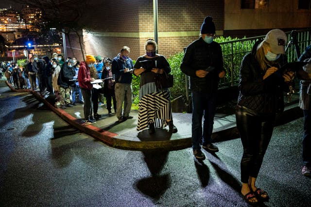 <p>People wait in line for a last-minute COVID-19 vaccine event at Seattle University after a freezer failure at a nearby hospital on January 29, 2021 in Seattle, Washington. The impromptu overnight event was one of three in the city, organized late at night at two University of Washington vaccine clinics and one Swedish Health Services vaccine clinic, to ensure COVID-19 vaccine doses from an area hospital did not go to waste.</p>