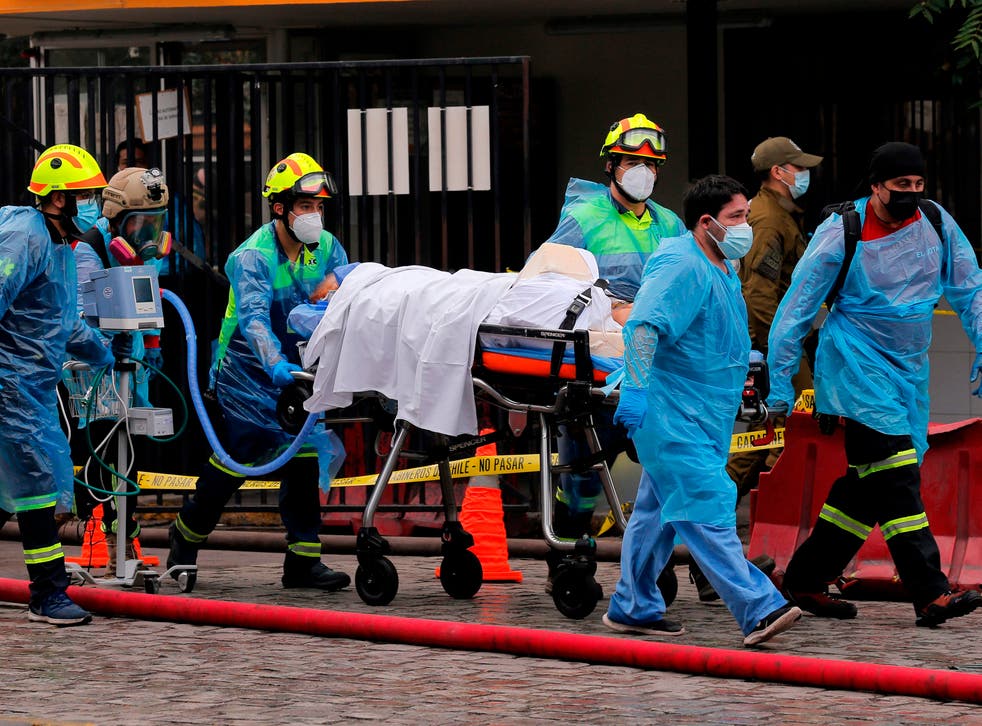 A patient is evacuated from the San Borja Hospital in Santiago
