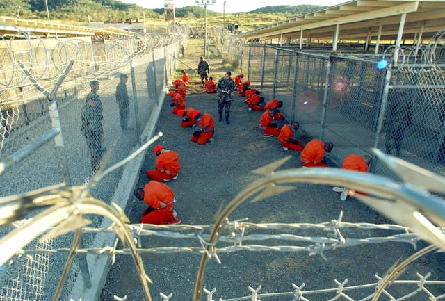 <p>File: US Military Police guard Taliban and al Qaeda detainees in orange jumpsuits in January, 2002</p>