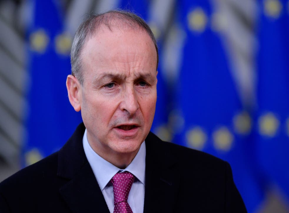 Ireland’s Prime Minister Micheál Martin speaks to the press as he arrives at the EU headquarters’ Europa building in Brussels on 10 December, 2020, prior to a European Union summit. The premier has urged calm in the race to vaccinate populations around the world.