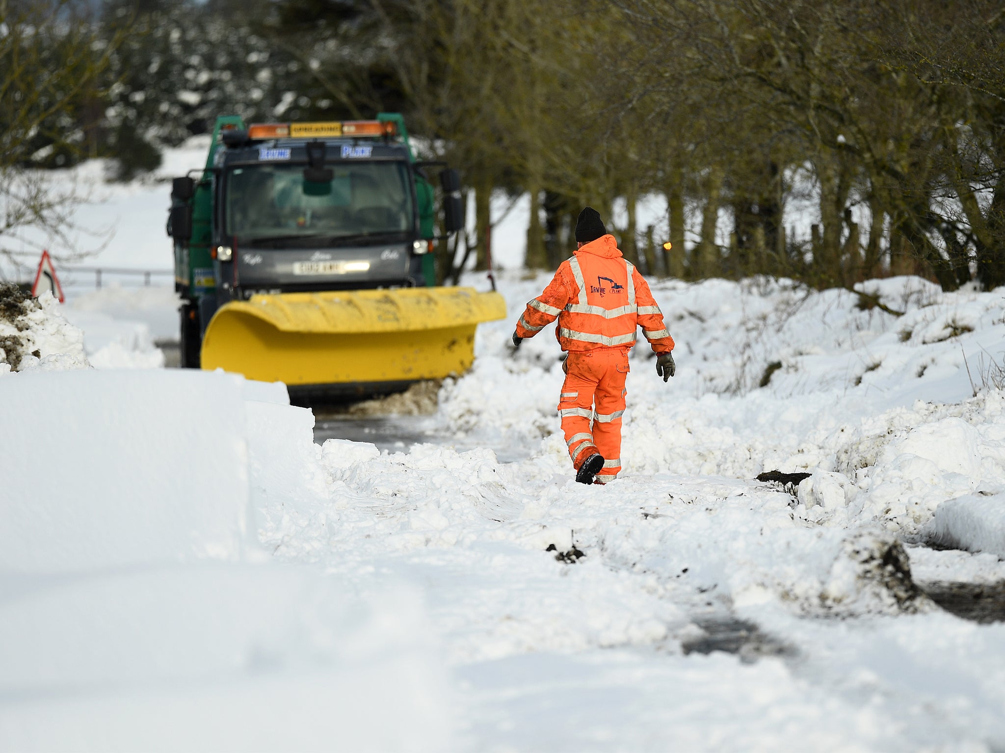 Clearing snow around a plough which had become stuck in a drift on 21 January in Lamancha, Scotland&nbsp;