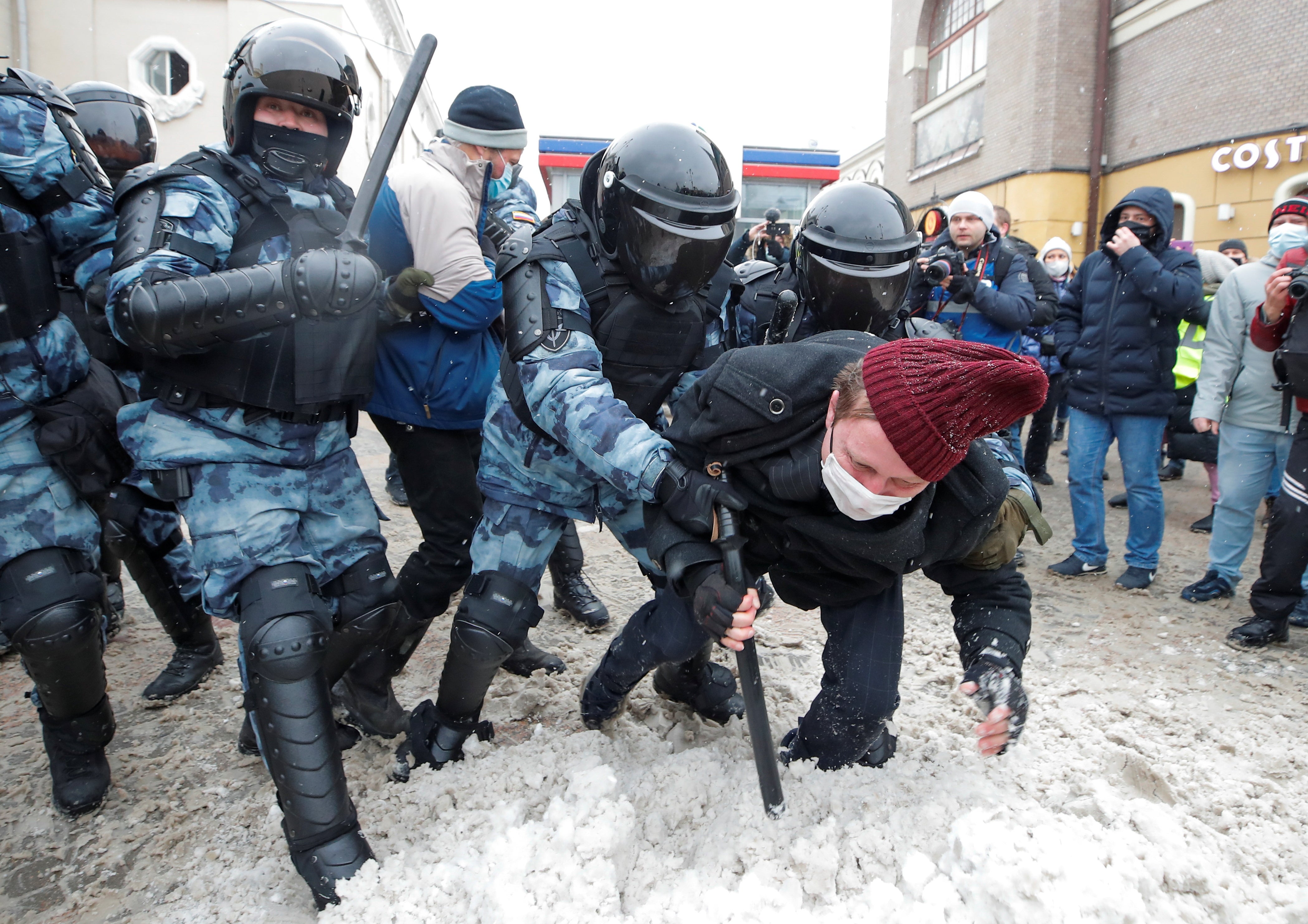 Law enforcement officers detain a protestor during a rally in support of jailed Russian opposition leader Alexei Navalny