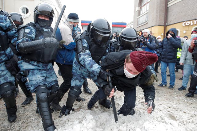 Law enforcement officers detain a protestor during a rally in support of jailed Russian opposition leader Alexei Navalny