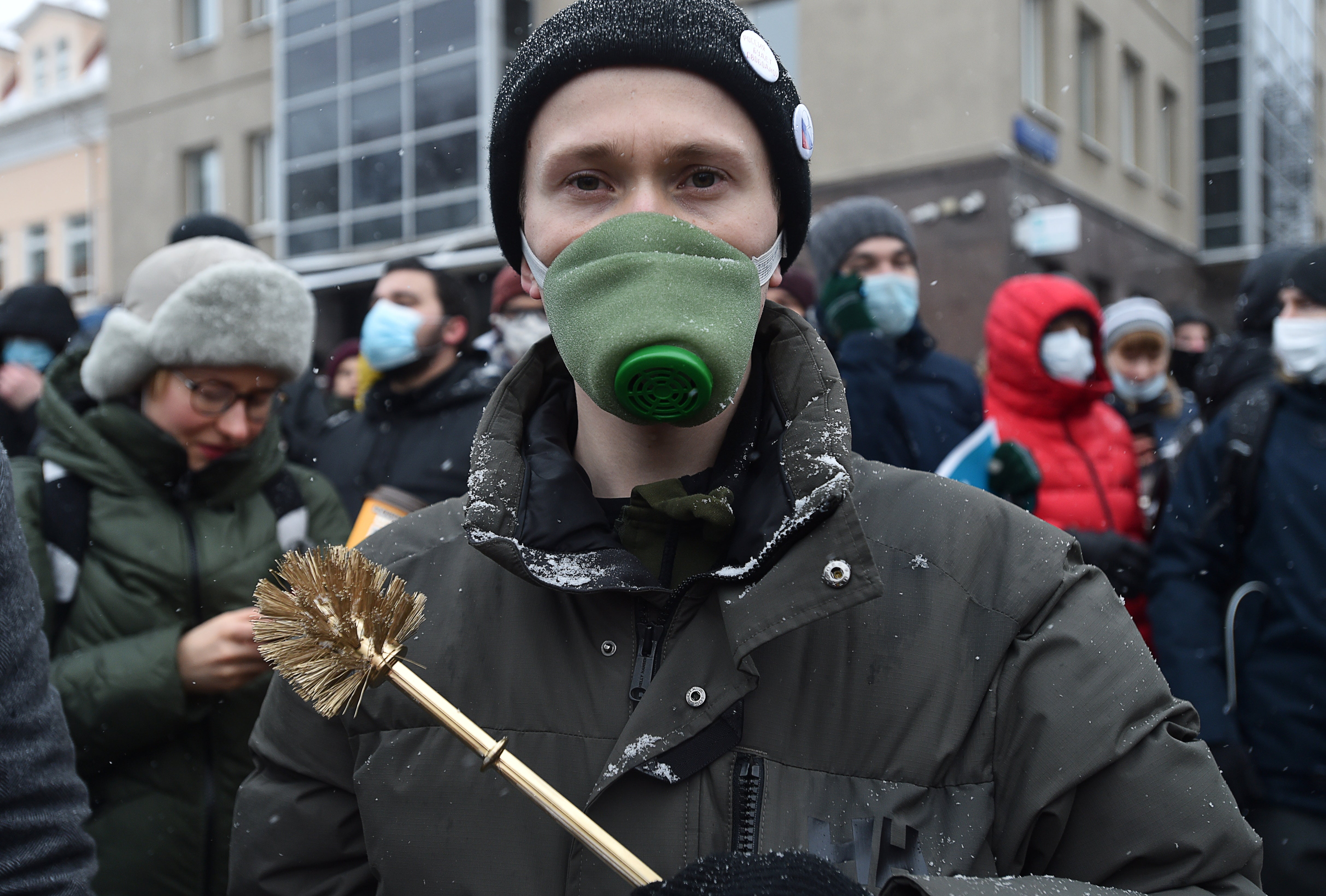 A demonstrator holds a toilet brush during a rally in support of jailed Russian opposition leader Alexei Navalny in Moscow