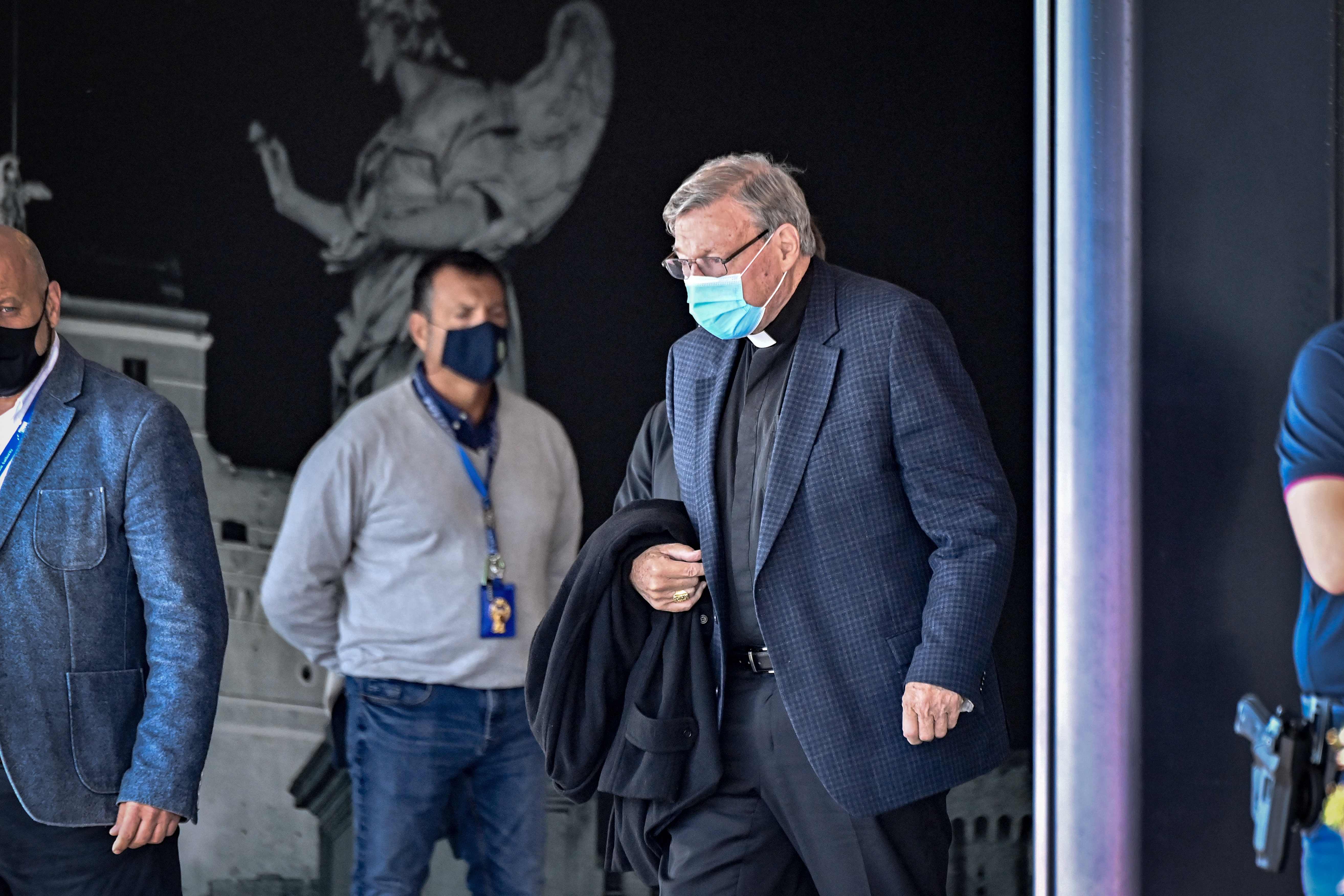 Australian Cardinal George Pell (C-R) prepares to get into a car after landing at Rome's Fiumicino airport on September 30, 2020, returning for the first time since being acquitted of sexual abuse charges. - Pell arrived from Sydney to Rome on September 30, 2020 on a "private visit", just six months after Australia's High Court quashed his conviction on charges of molesting two choirboys in the 1990s.&nbsp;