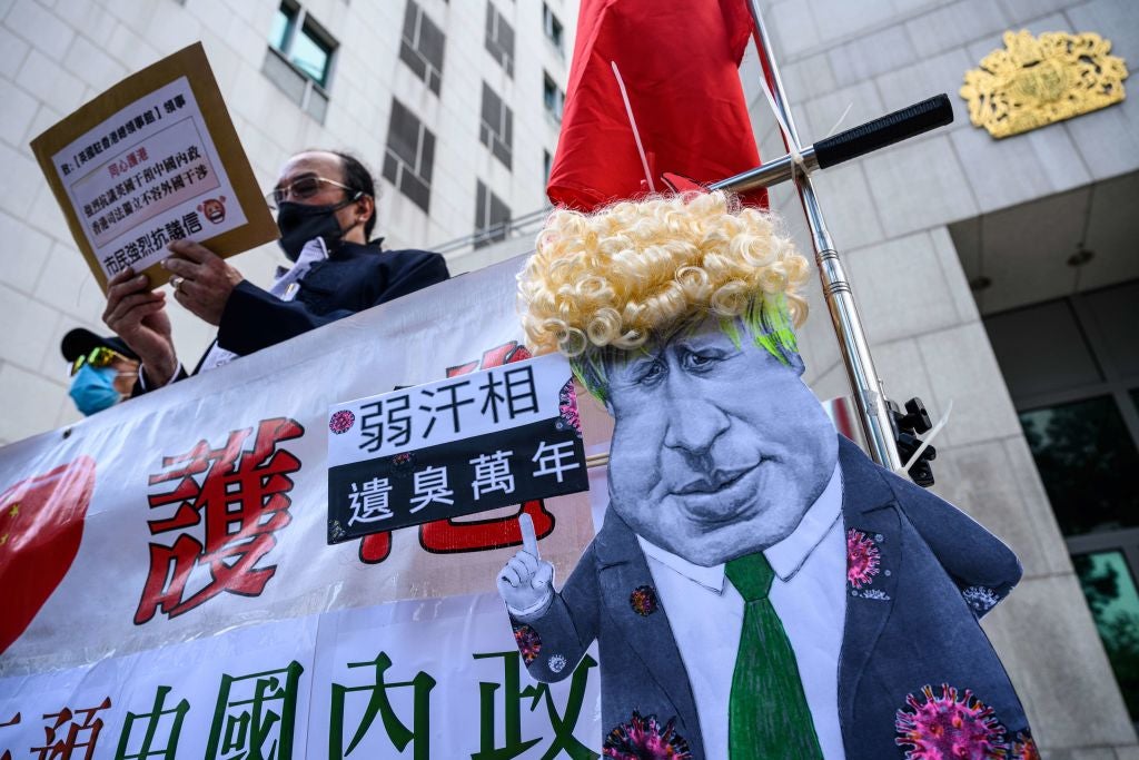 Pro-Beijing activists gather outside the British Consulate-General on Tuesday to protest against the use of BNO visas in Hong Kong&nbsp;