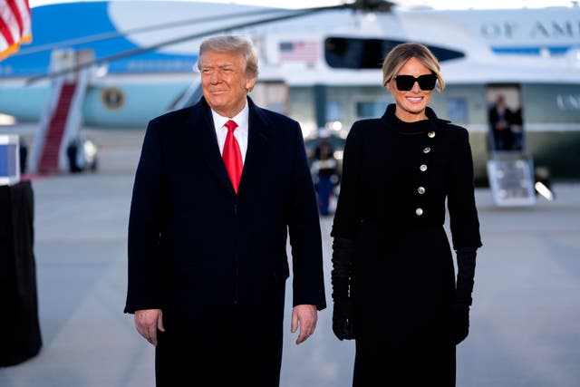 <p>Donald Trump, left, and US First Lady Melania Trump, arrive to a farewell ceremony at Joint Base Andrews, Maryland, on 20 January 2021</p>