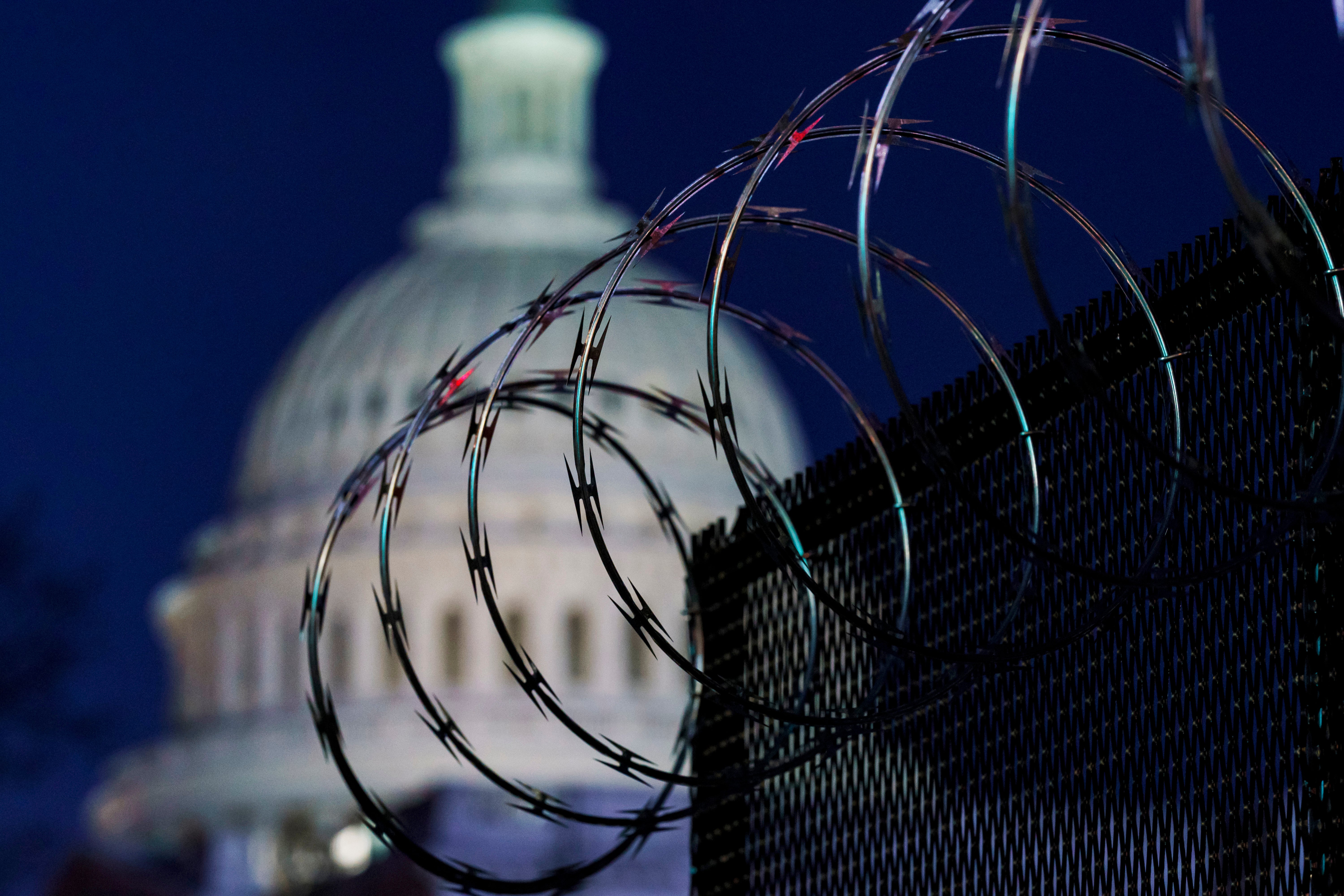 File: Riot fencing and razor wire reinforce the security zone on Capitol Hill in Washington