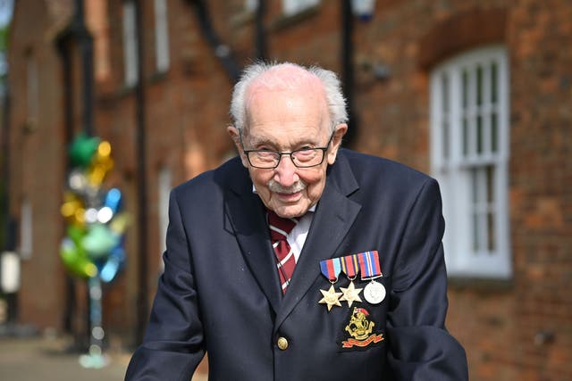 <p>War veteran Sir Tom doing a lap of his garden to raise money for charity</p>