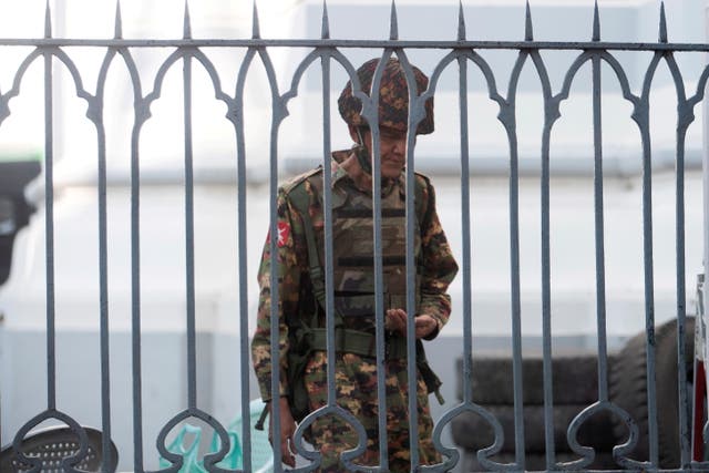 <p>Myanmar soldiers look on as they stand inside Yangon city hall after they occupied the building</p>
