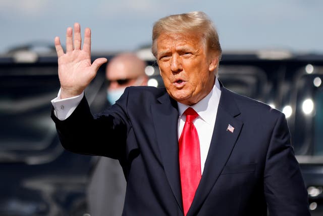 Donald Trump waves as he arrives at Palm Beach International Airport in West Palm Beach, Florida, on 20 January 2021